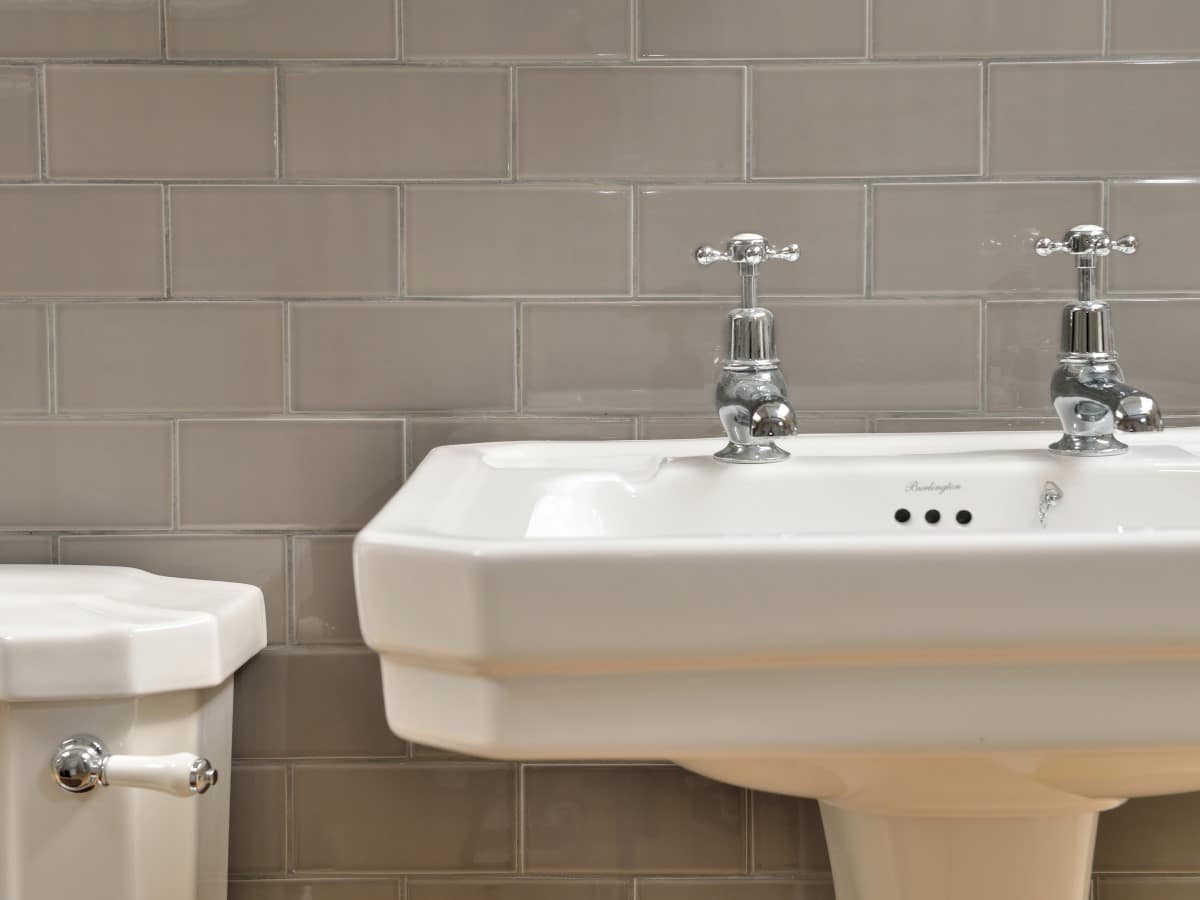 dark grey brick splash back against traditional sanitary ware