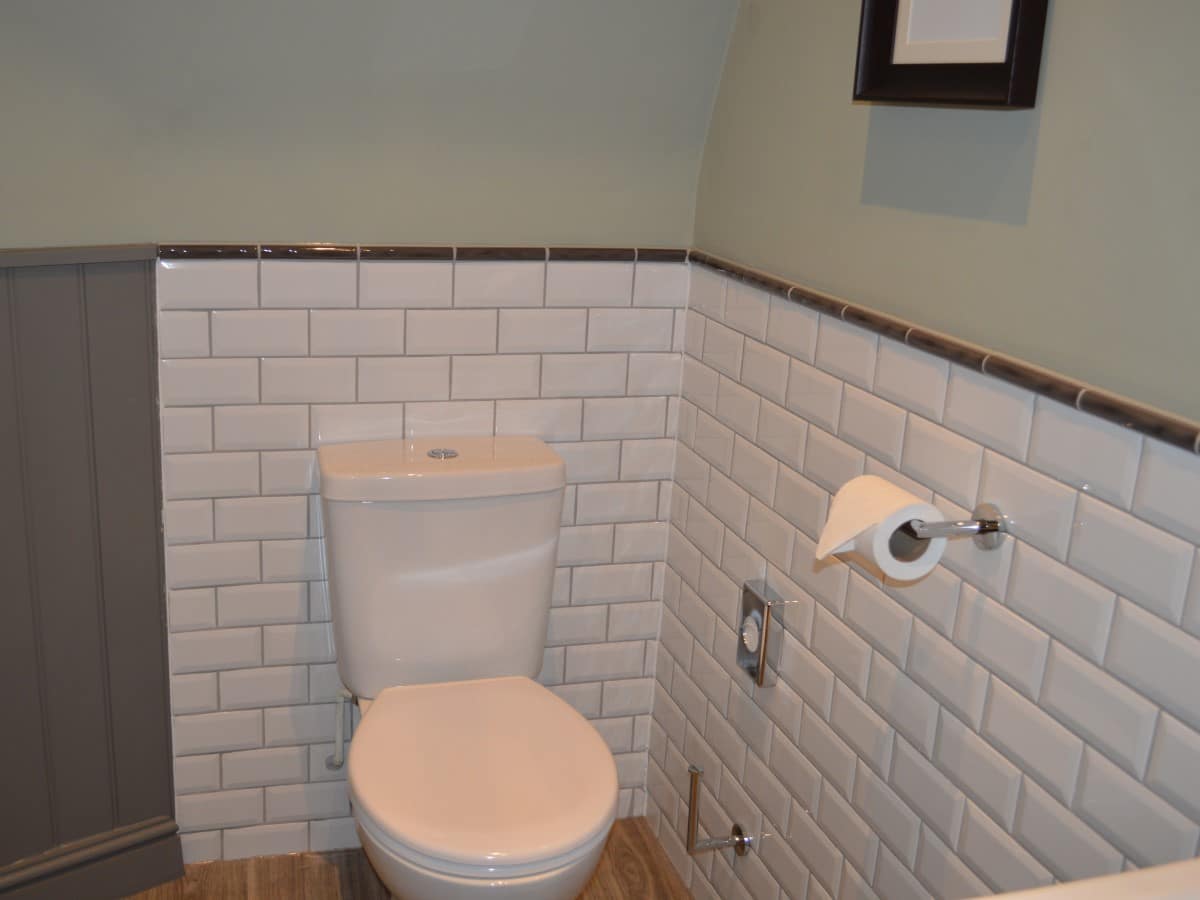 Bevelled white tiles used half height in a bathroom redesign