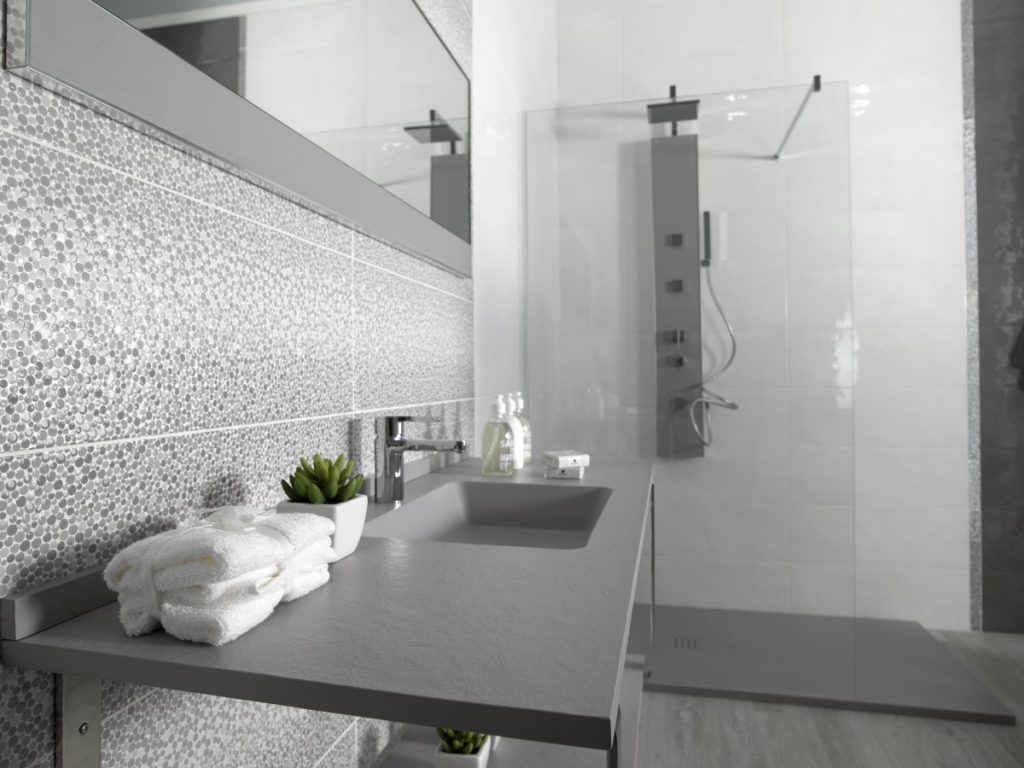 up to date bathroom with a think minimalist basin and unique grey decor tile