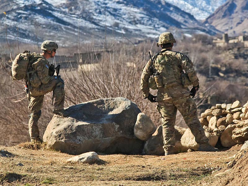 soldiers on lookout in a war zone