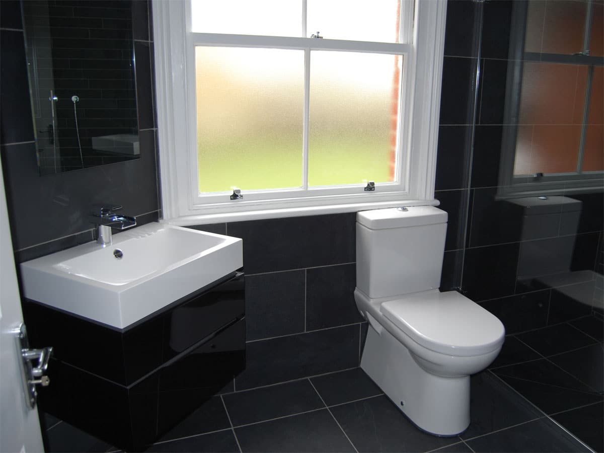 slate tiled bathroom setting with a walk in shower