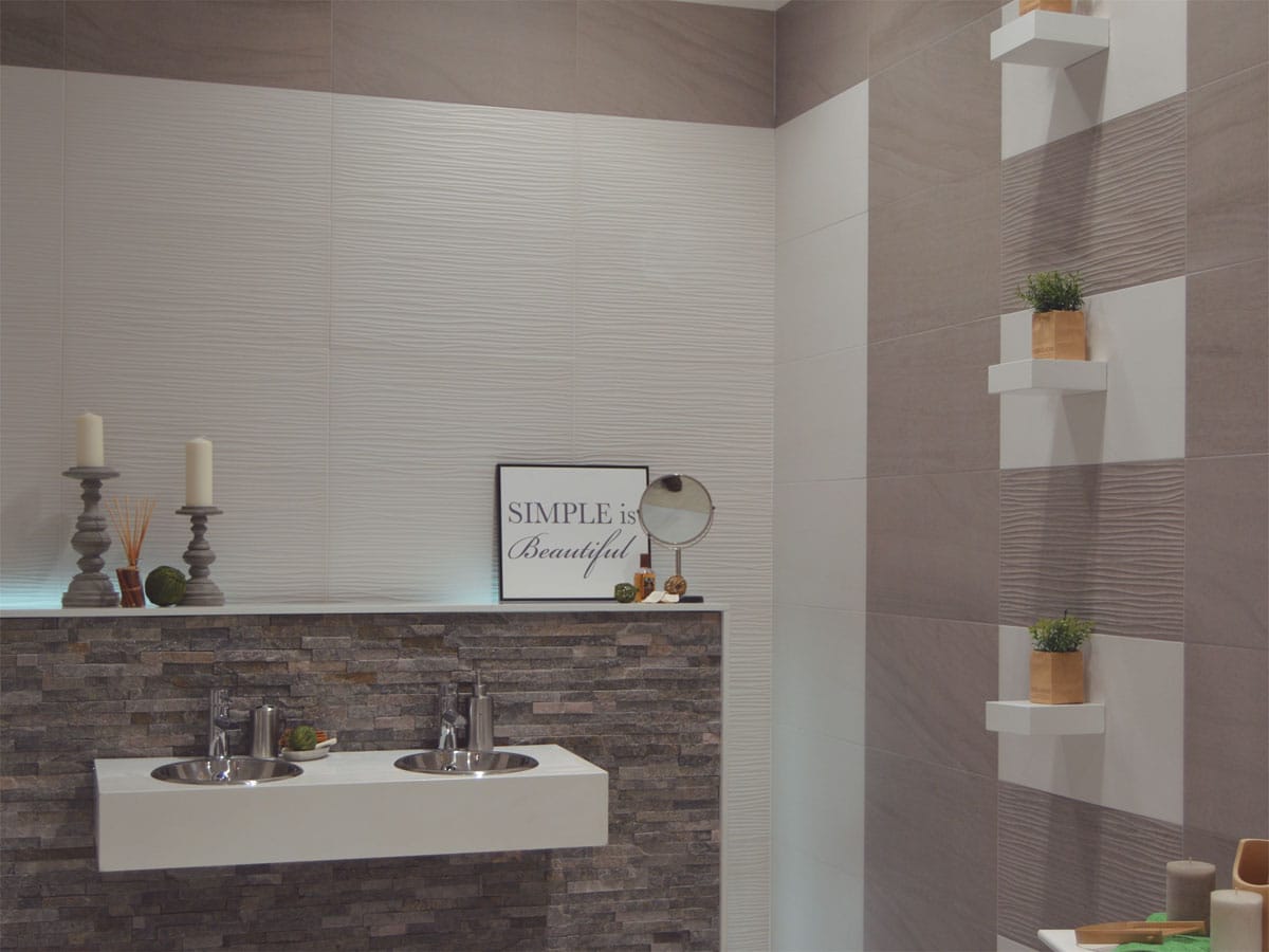 a modern styled bathroom with double basin and uniquely tiled walls