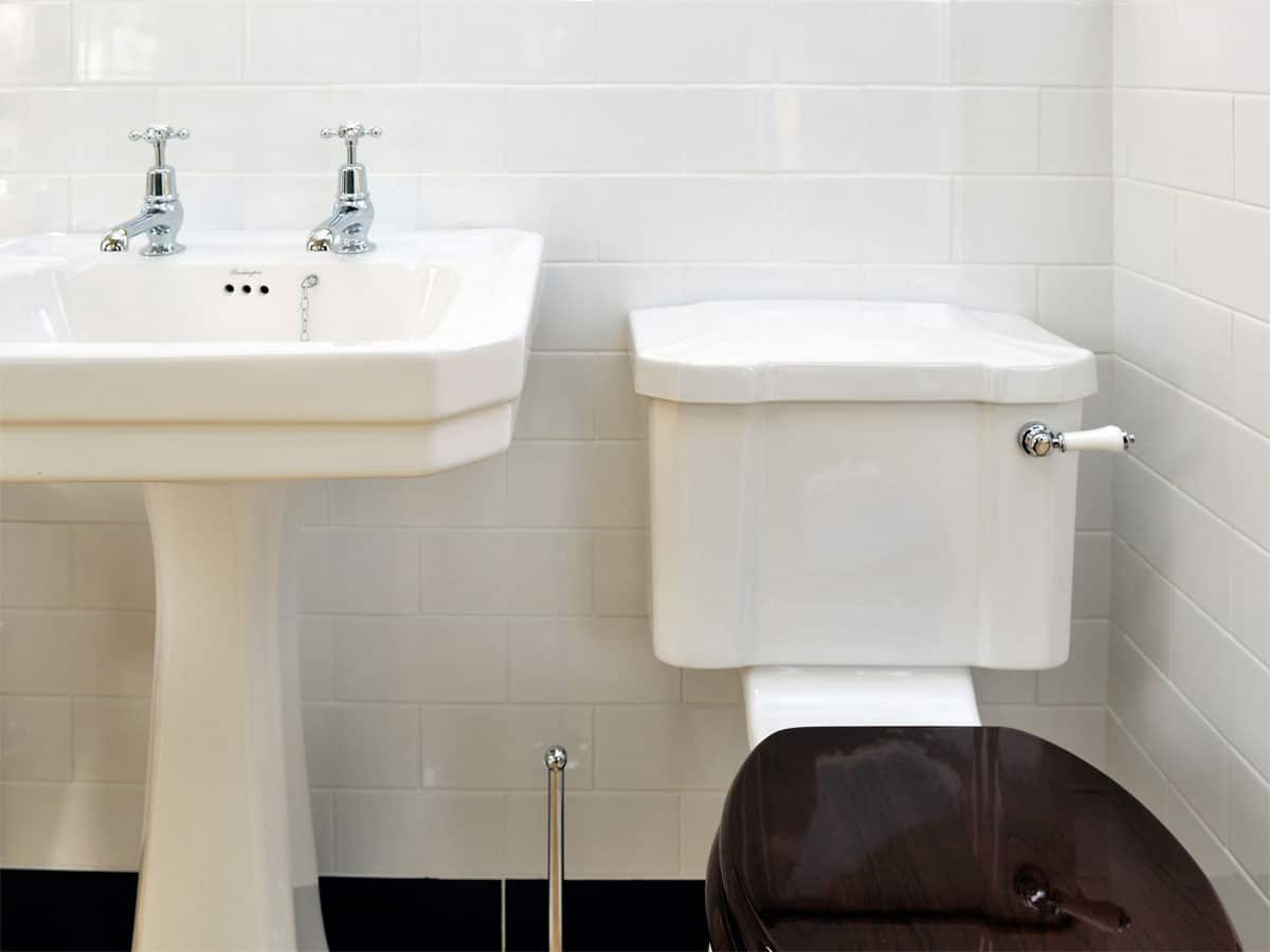 a traditional styled cloakroom with white tiles