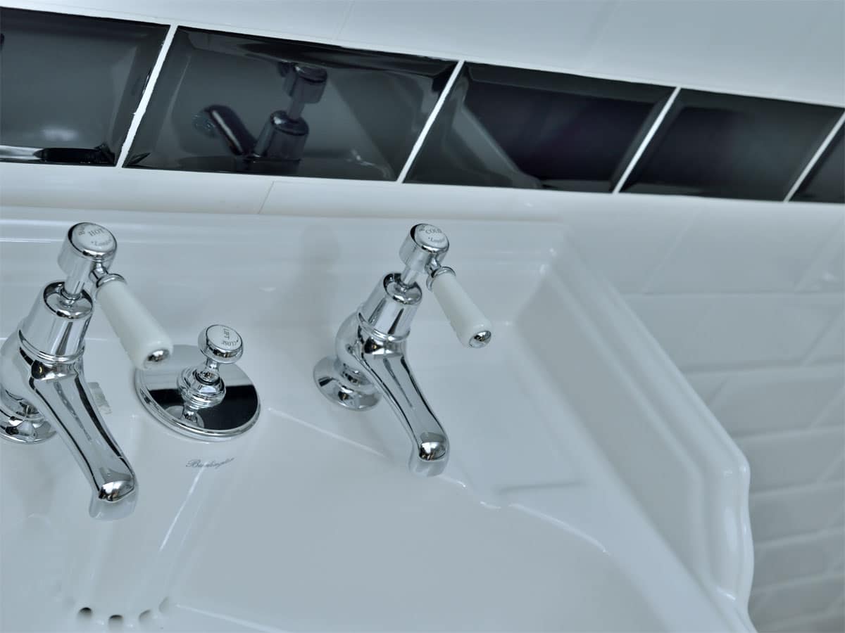 beveled tiled splashback against a traditional basin