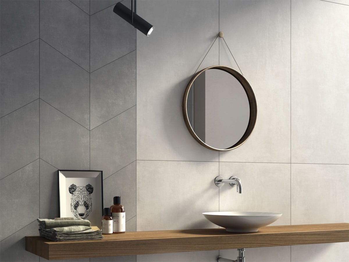 unique chic round mirror on a tiled wall with rhombus shaped feature tiles